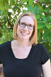 Stacey Rainey smiling in front of greenery