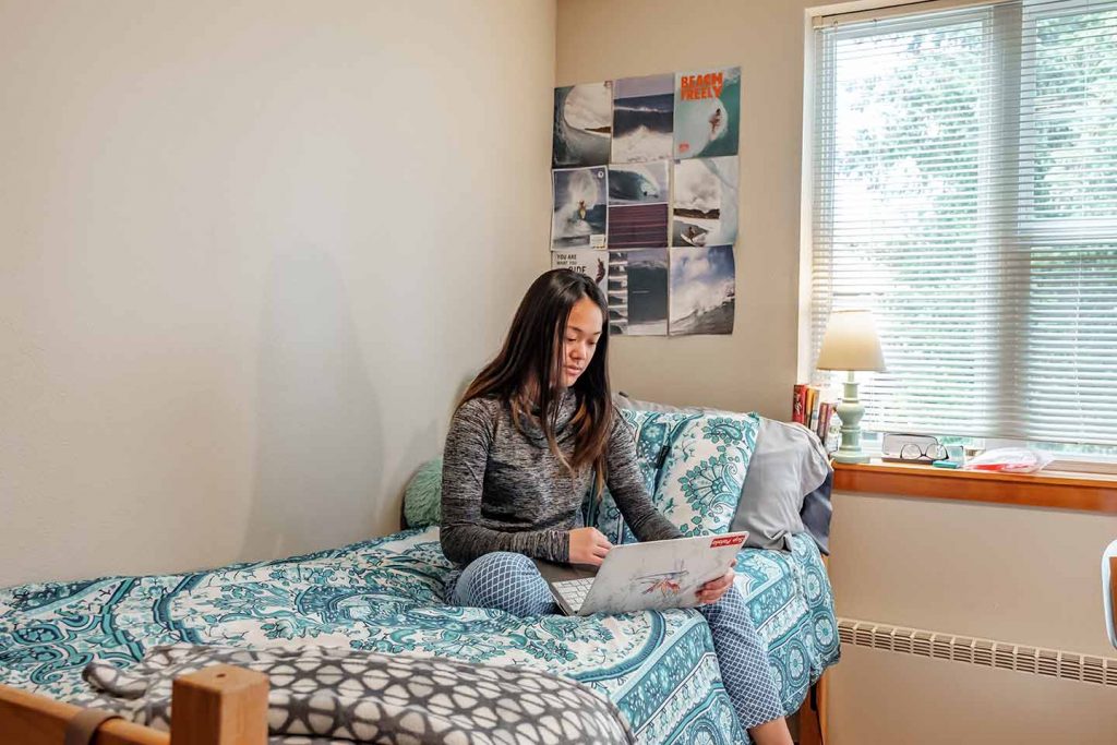 WOU student on her bed