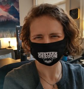 mask selfie - Bev Bev West wearing a a black WOU non-surgical mask in her office