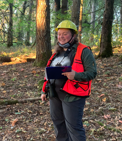 Photo of student researcher in forest.