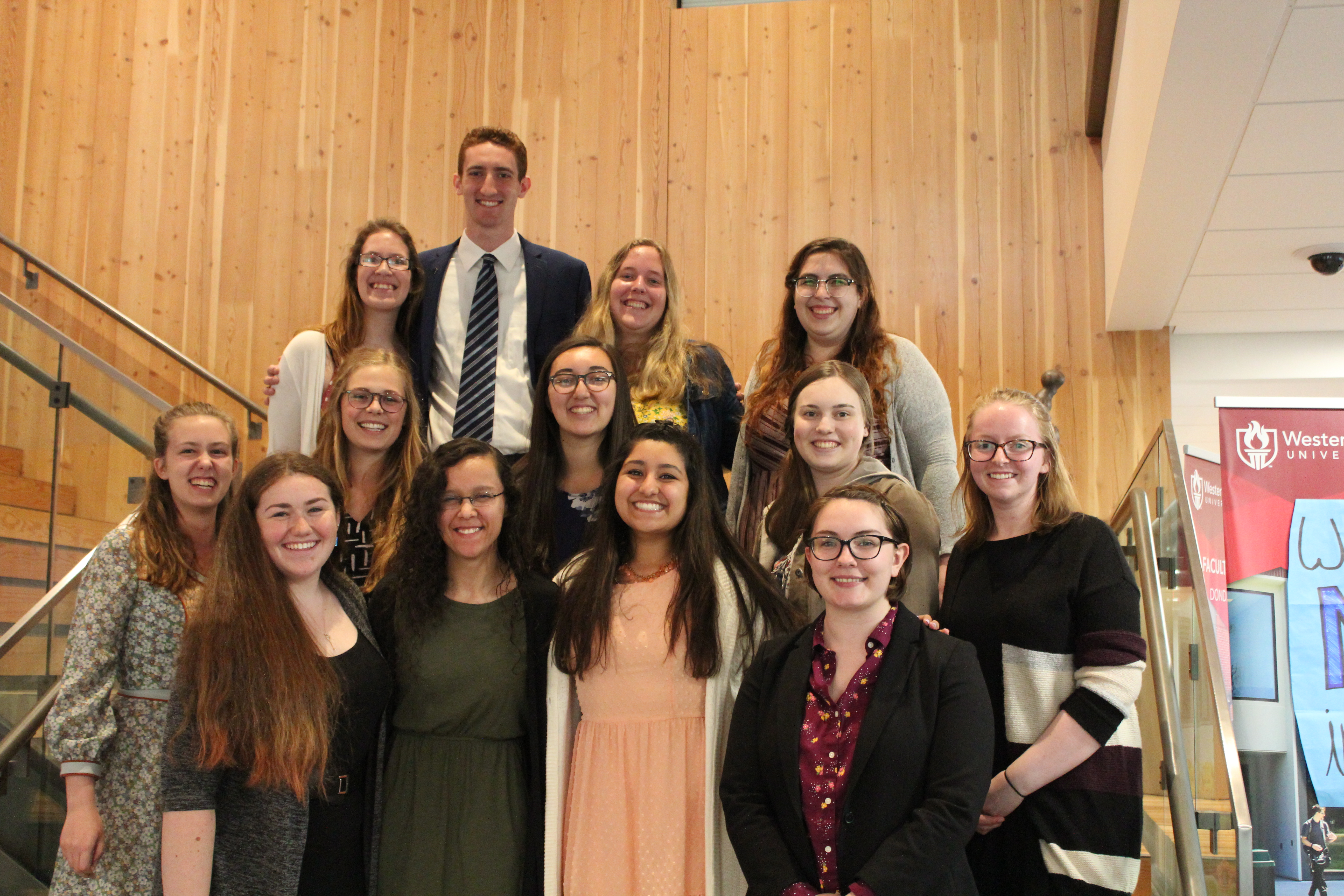 NRHH Wolf Chapter with new and old members stands on the steps in the RWEC.