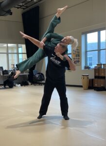 Tim Cowart lifting a female dancer above his head